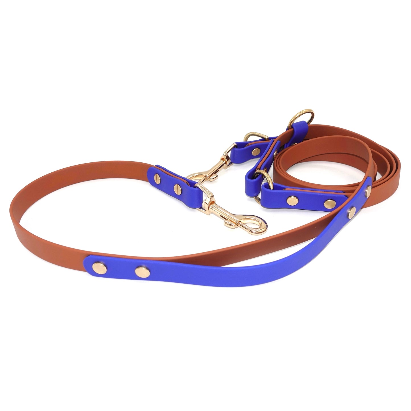 Blue and brown dog leash with traffic handle and gold hardware on a white background