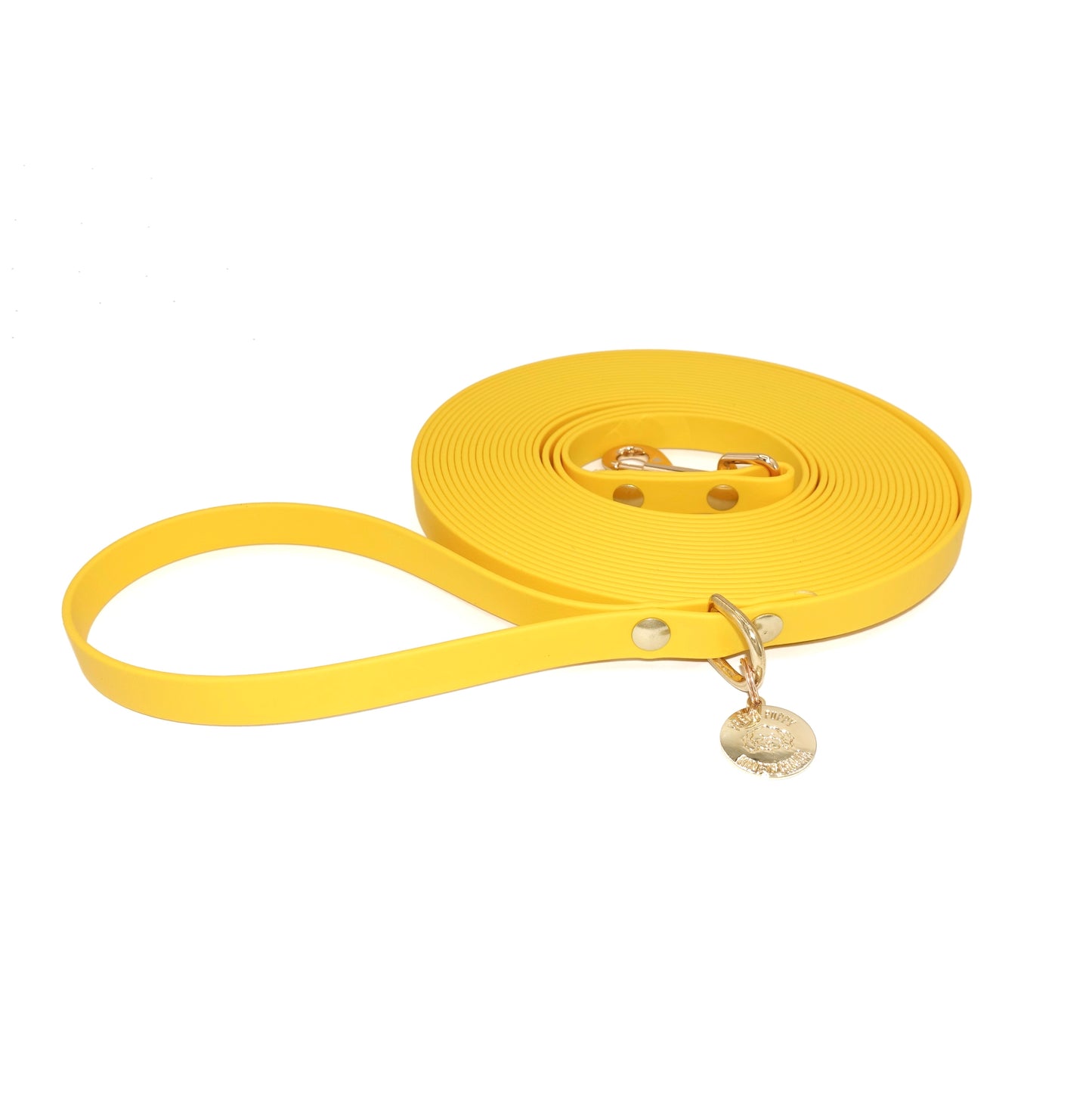 Yellow long line dog leash with a gold clasp on a white background
