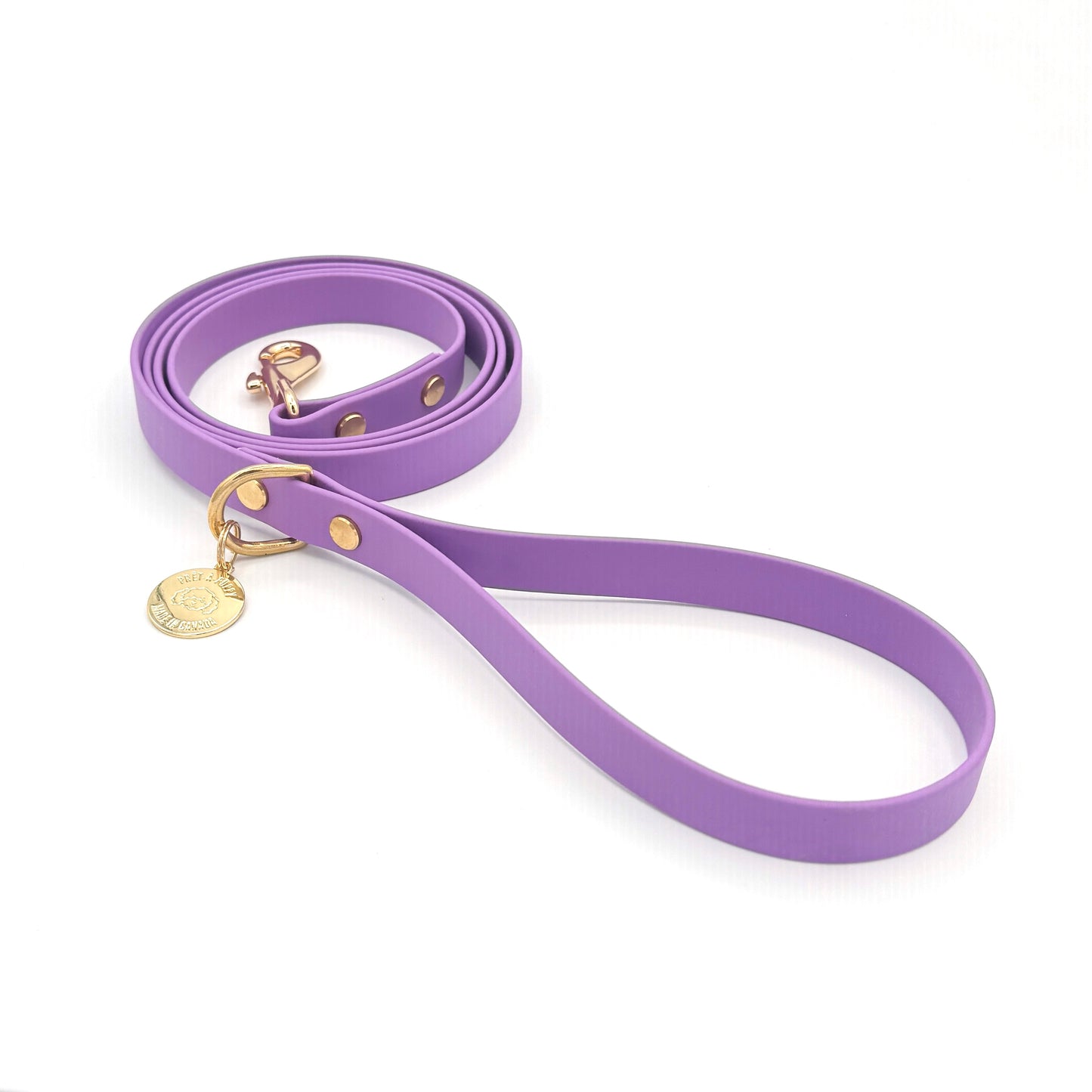 Stylish purple dog leash made from high-quality vegan leather, featuring elegant gold hardware. This waterproof leash is soft to the touch, ensuring comfort for pet owners while providing durability for everyday walks. Ideal for pet owners looking for a fashionable, and long-lasting accessory for their dog