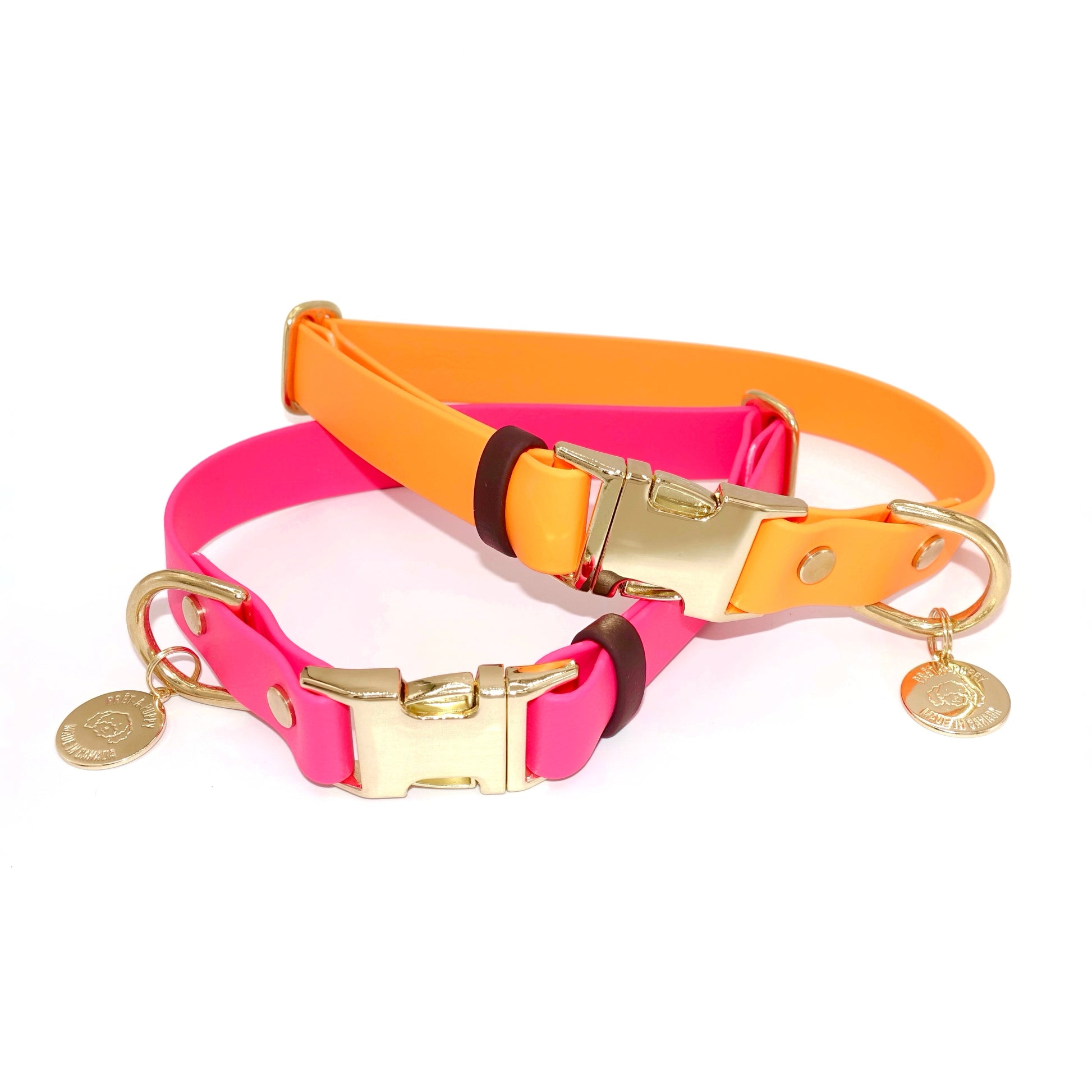 Adjustable Biothane dog collar with gold quick release buckle and hardware in orange and hot pink