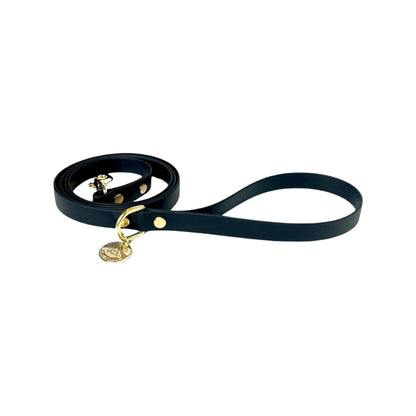 Stylish black dog leash made from high-quality vegan leather, featuring elegant gold hardware. This waterproof leash is soft to the touch, ensuring comfort for pet owners while providing durability for everyday walks. Ideal for pet owners looking for a fashionable, and long-lasting accessory for their dog