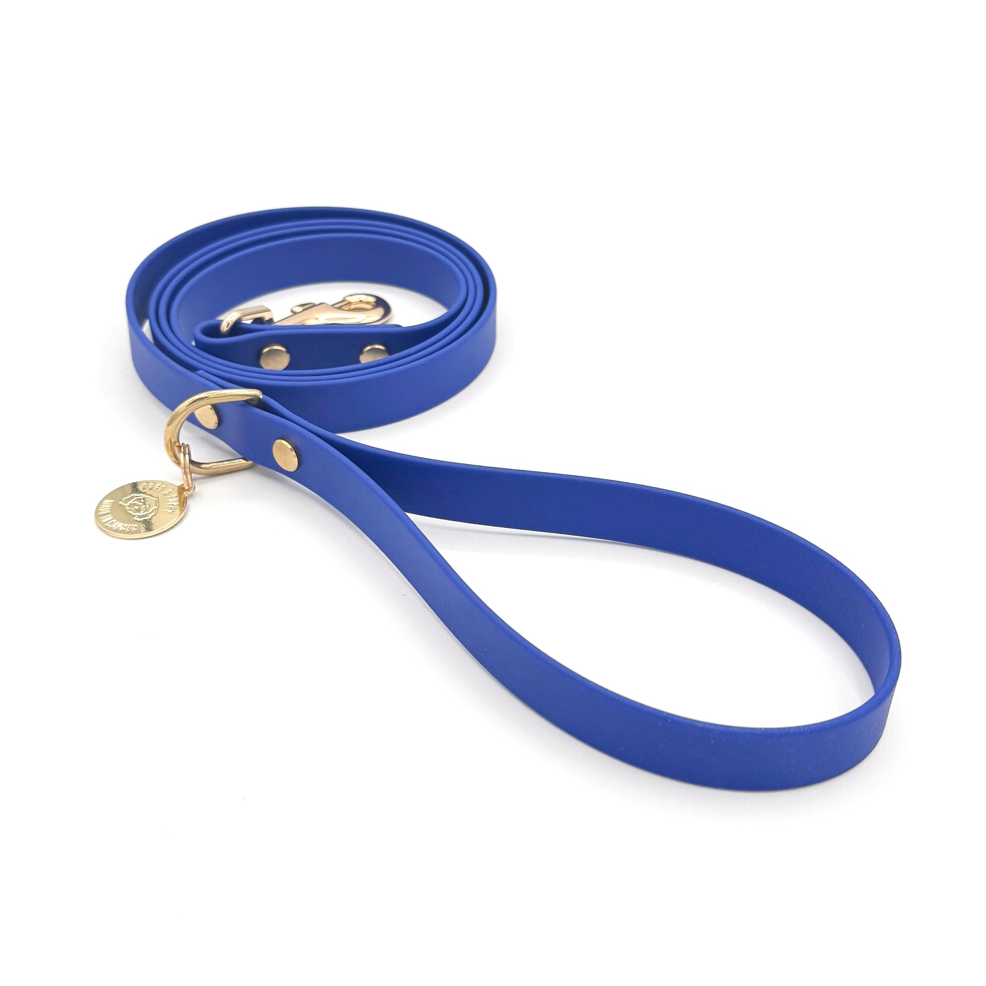 Stylish royal blue dog leash made from high-quality vegan leather, featuring elegant gold hardware. This waterproof leash is soft to the touch, ensuring comfort for pet owners while providing durability for everyday walks. Ideal for pet owners looking for a fashionable, and long-lasting accessory for their dog