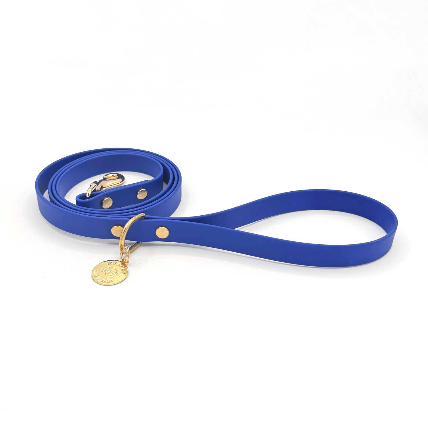 Stylish royal blue dog leash made from high-quality vegan leather, featuring elegant gold hardware. This waterproof leash is soft to the touch, ensuring comfort for pet owners while providing durability for everyday walks. Ideal for pet owners looking for a fashionable, and long-lasting accessory for their dog