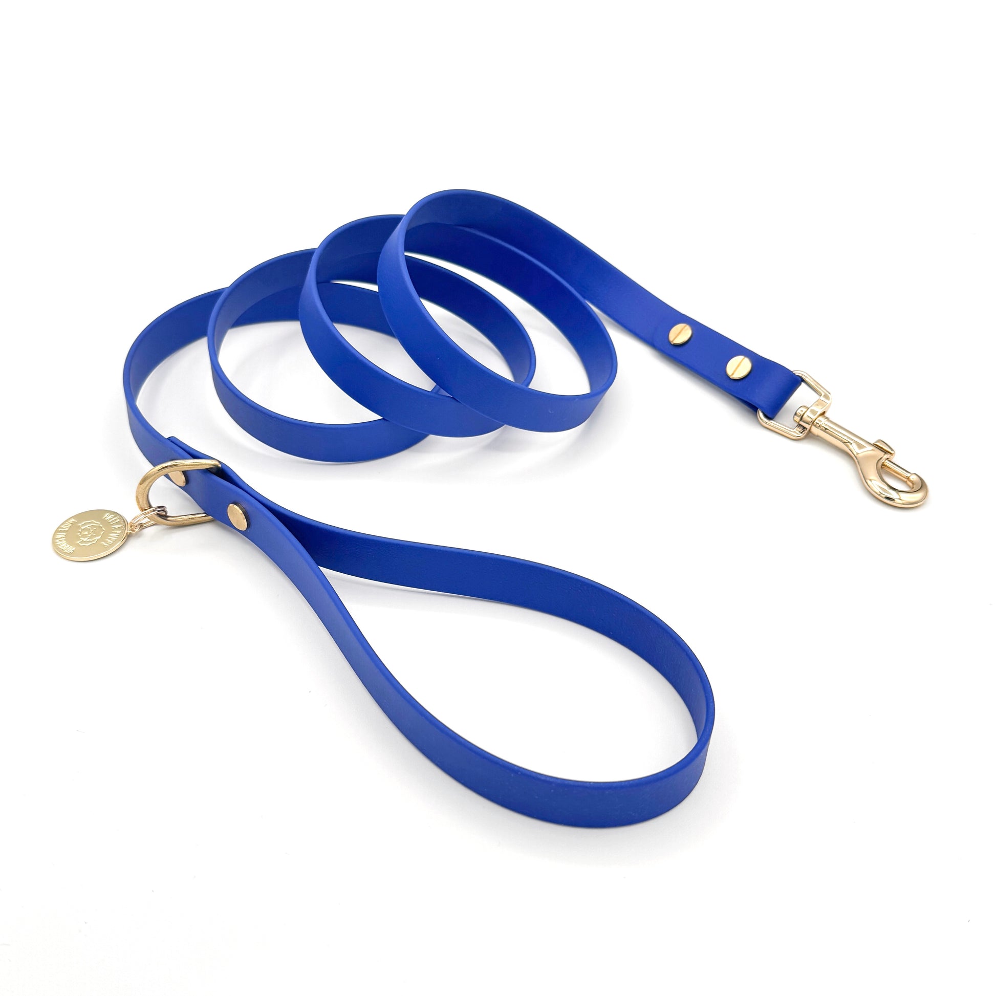 Stylish royal blue dog leash made from high-quality vegan leather, featuring elegant gold hardware. This waterproof leash is soft to the touch, ensuring comfort for pet owners while providing durability for everyday walks. Ideal for pet owners looking for a fashionable, and long-lasting accessory for their dog