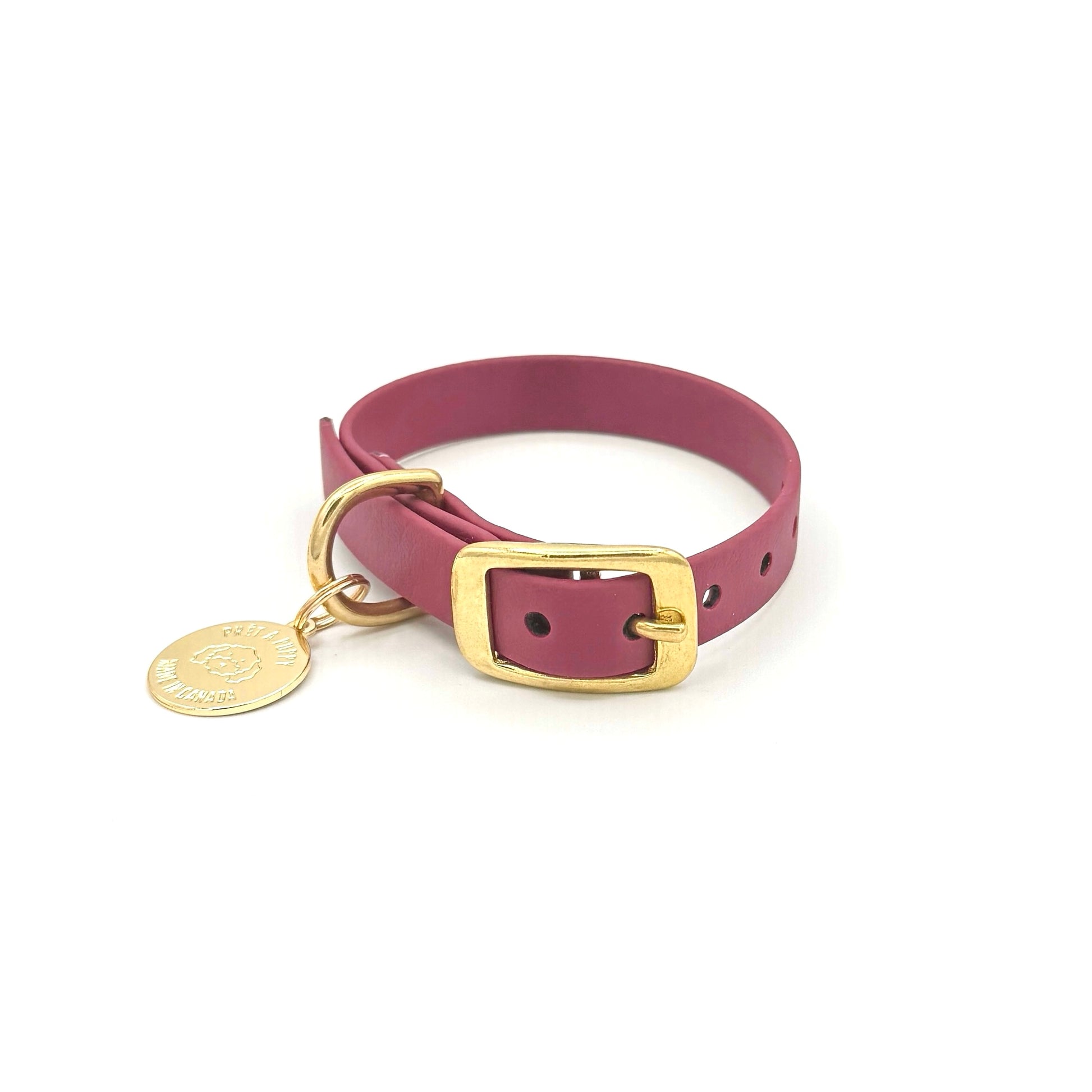 Stylish burgundy dog collar made from high-quality vegan leather, featuring elegant gold hardware. This waterproof collar is soft to the touch, ensuring comfort for your pet while providing durability for everyday use. Ideal for pet owners looking for a fashionable, and long-lasting accessory for their dog.