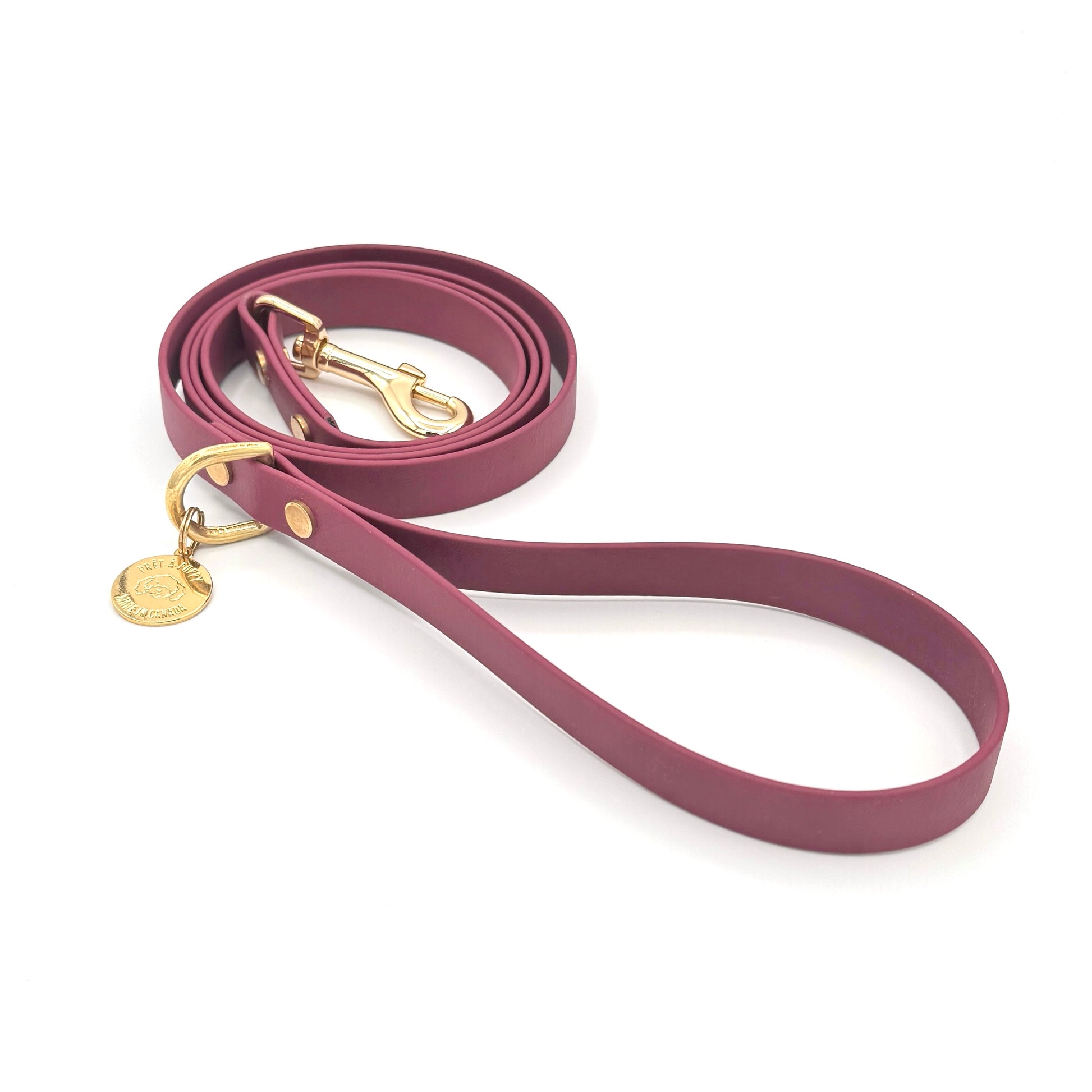 Stylish burgundy dog leash made from high-quality vegan leather, featuring elegant gold hardware. This waterproof leash is soft to the touch, ensuring comfort for pet owners while providing durability for everyday walks. Ideal for pet owners looking for a fashionable, and long-lasting accessory for their dog