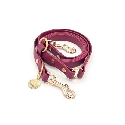 Burgundy Biothane hands-free dog leash with gold hardware, waterproof and versatile for waist or crossbody wear