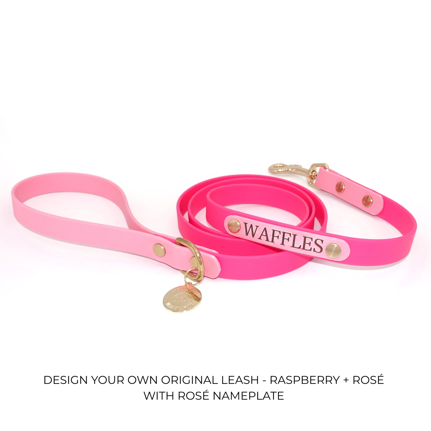 Pink dog leash with 'Waffles' nameplate on a white background