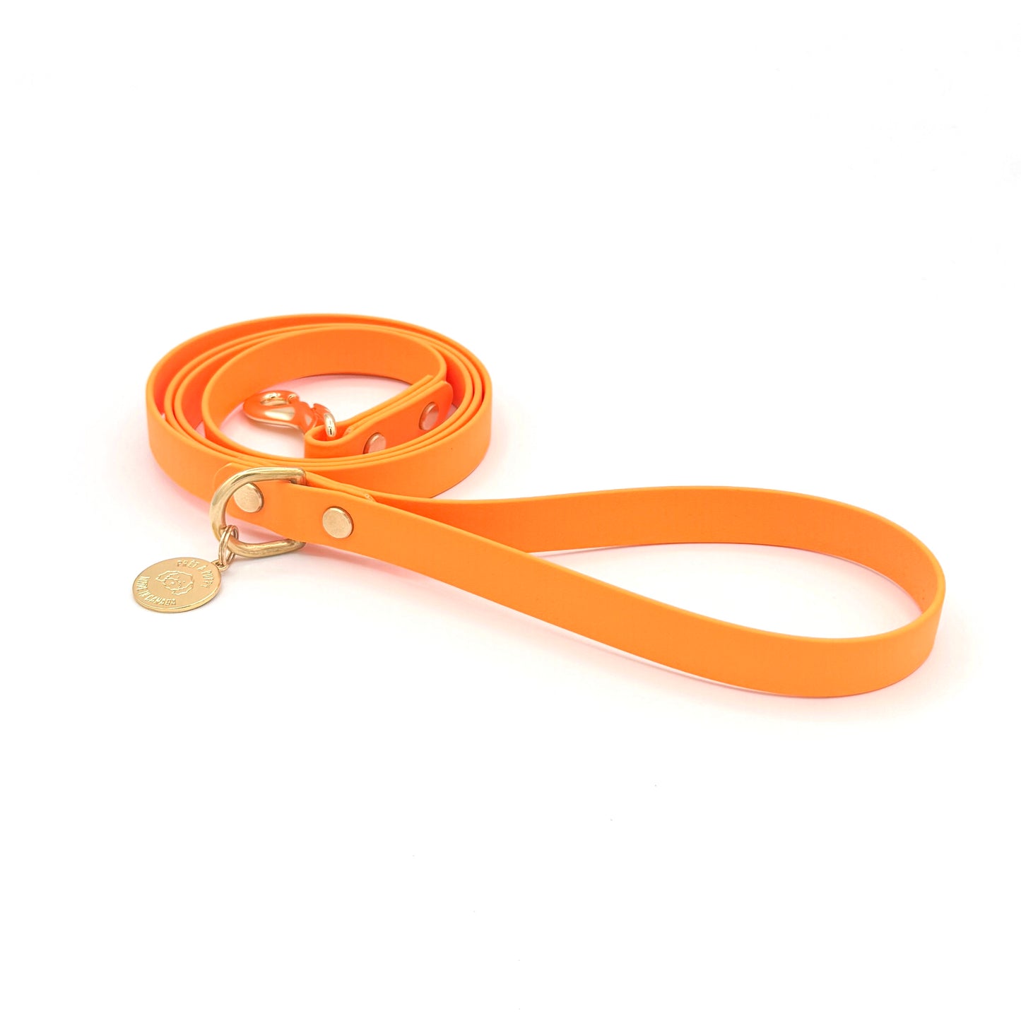 Stylish orange dog leash made from high-quality vegan leather, featuring elegant gold hardware. This waterproof leash is soft to the touch, ensuring comfort for pet owners while providing durability for everyday walks. Ideal for pet owners looking for a fashionable, and long-lasting accessory for their dog