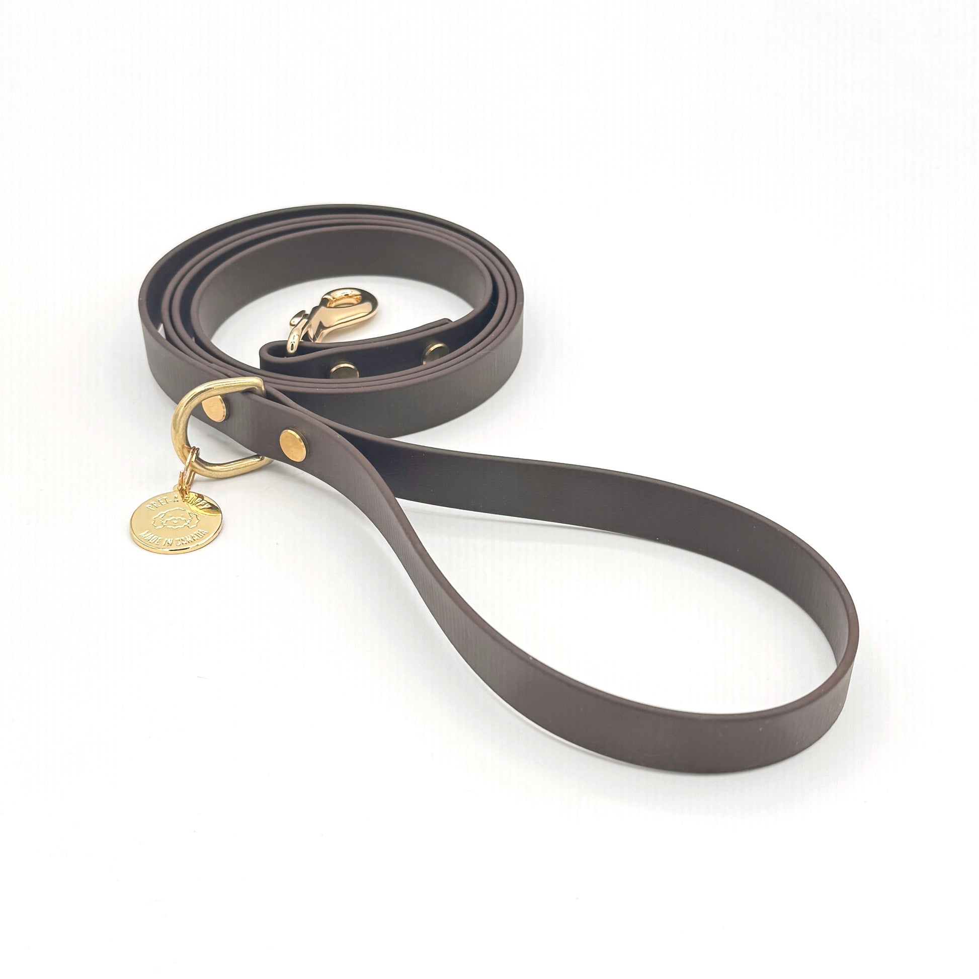 Stylish espresso dark brown dog leash made from high-quality vegan leather, featuring elegant gold hardware. This waterproof leash is soft to the touch, ensuring comfort for pet owners while providing durability for everyday walks. Ideal for pet owners looking for a fashionable, and long-lasting accessory for their dog