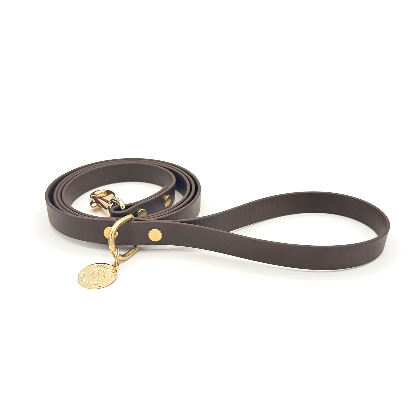 Stylish espresso dark brown dog leash made from high-quality vegan leather, featuring elegant gold hardware. This waterproof leash is soft to the touch, ensuring comfort for pet owners while providing durability for everyday walks. Ideal for pet owners looking for a fashionable, and long-lasting accessory for their dog