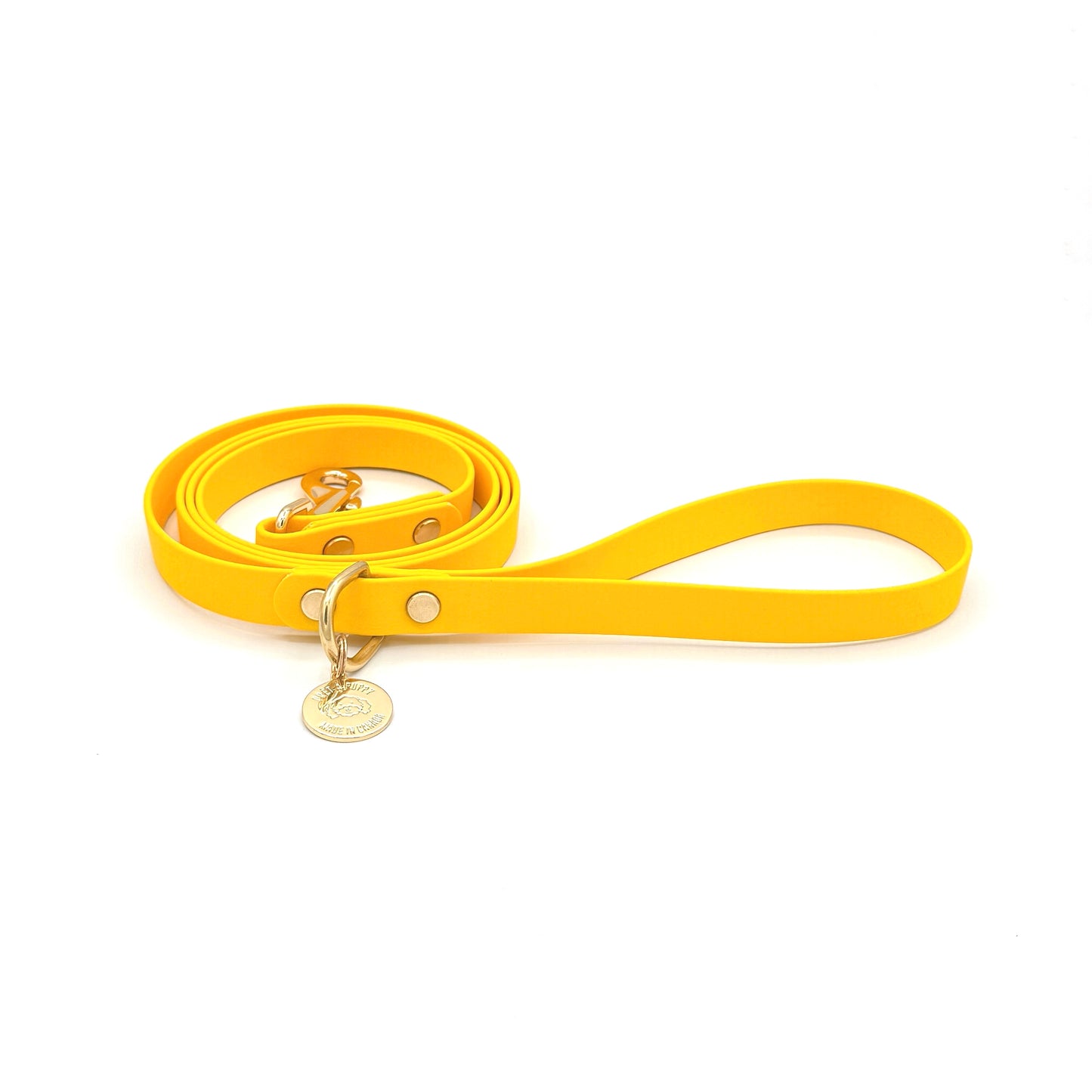 Stylish yellow dog leash made from high-quality vegan leather, featuring elegant gold hardware. This waterproof leash is soft to the touch, ensuring comfort for pet owners while providing durability for everyday walks. Ideal for pet owners looking for a fashionable, and long-lasting accessory for their dog