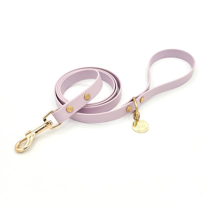 Stylish lilac light purple dog leash made from high-quality vegan leather, featuring elegant gold hardware. This waterproof leash is soft to the touch, ensuring comfort for pet owners while providing durability for everyday walks. Ideal for pet owners looking for a fashionable, and long-lasting accessory for their dog