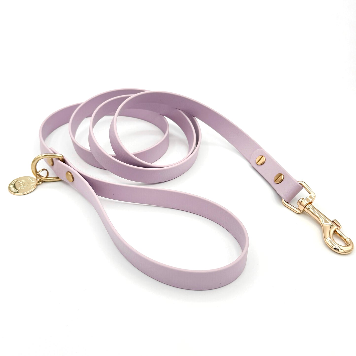 Stylish lilac light purple dog leash made from high-quality vegan leather, featuring elegant gold hardware. This waterproof leash is soft to the touch, ensuring comfort for pet owners while providing durability for everyday walks. Ideal for pet owners looking for a fashionable, and long-lasting accessory for their dog