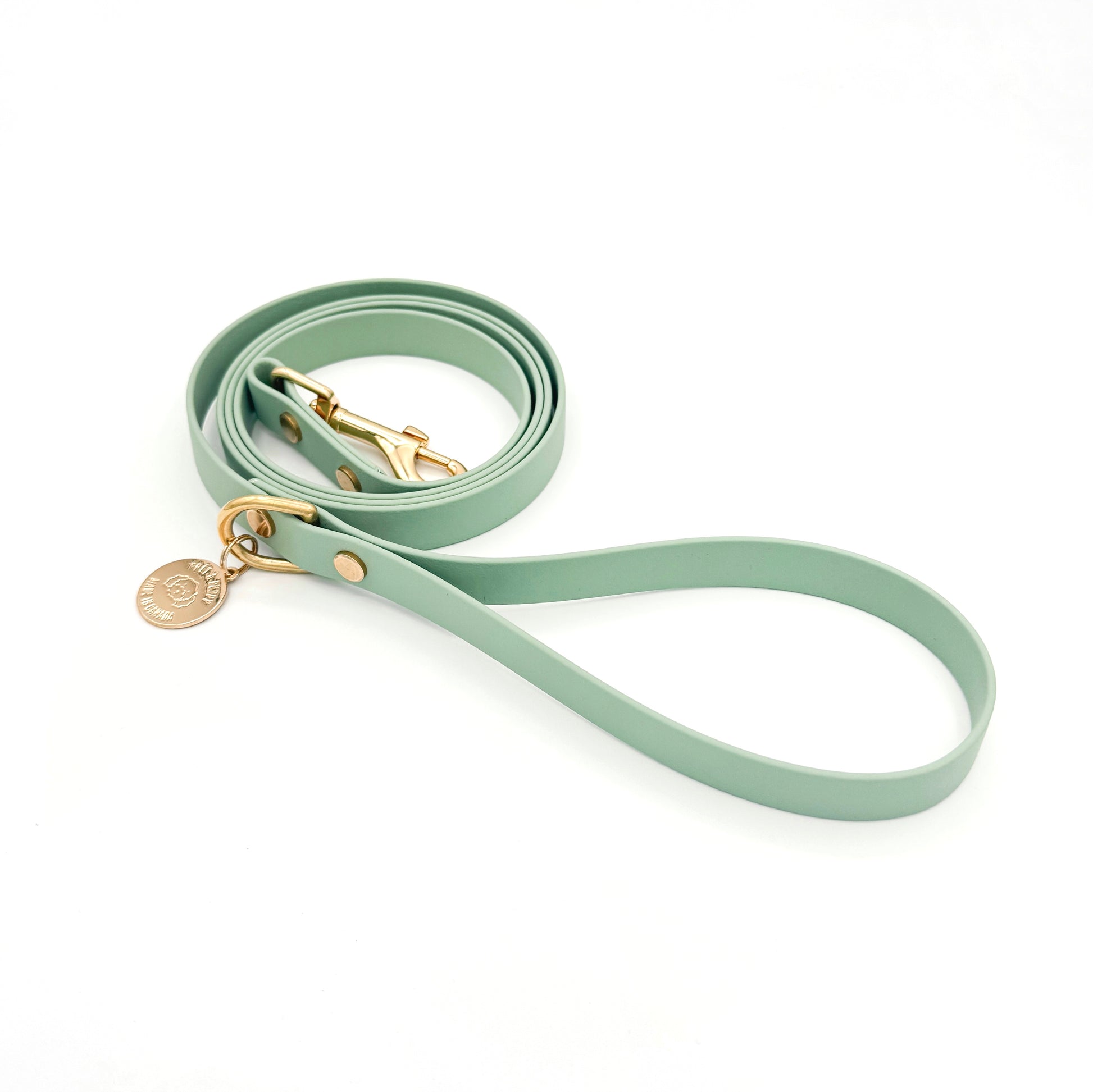 Stylish sage green dog leash made from high-quality vegan leather, featuring elegant gold hardware. This waterproof leash is soft to the touch, ensuring comfort for pet owners while providing durability for everyday walks. Ideal for pet owners looking for a fashionable, and long-lasting accessory for their dog