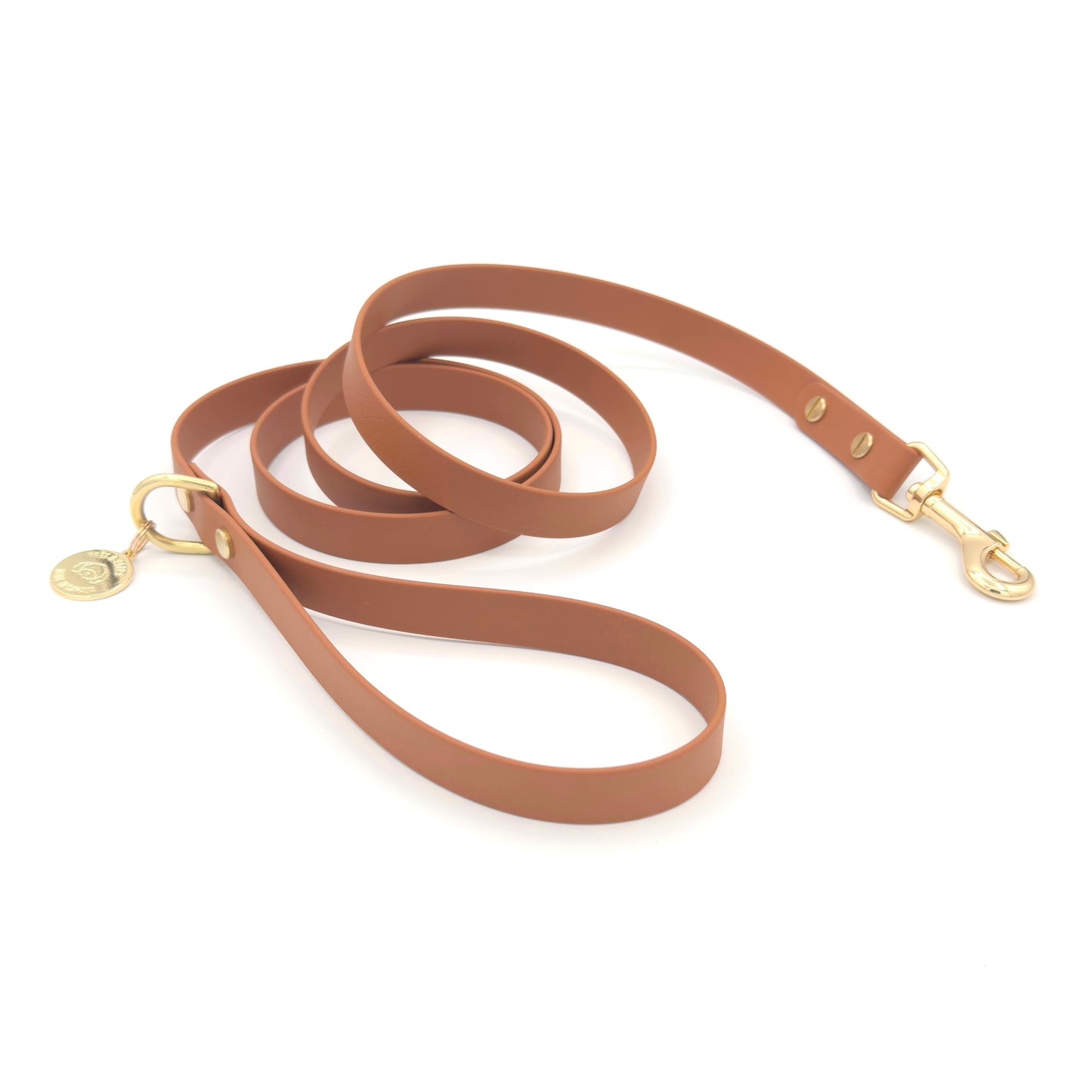 Stylish tan light brown dog leash made from high-quality vegan leather, featuring elegant gold hardware. This waterproof leash is soft to the touch, ensuring comfort for pet owners while providing durability for everyday walks. Ideal for pet owners looking for a fashionable, and long-lasting accessory for their dog