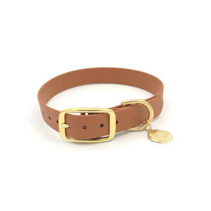 Stylish tan brown dog collar made from high-quality vegan leather, featuring elegant gold hardware. This waterproof collar is soft to the touch, ensuring comfort for your pet while providing durability for everyday use. Ideal for pet owners looking for a fashionable, and long-lasting accessory for their dog.