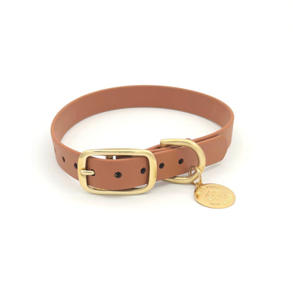 Stylish tan brown dog collar made from high-quality vegan leather, featuring elegant gold hardware. This waterproof collar is soft to the touch, ensuring comfort for your pet while providing durability for everyday use. Ideal for pet owners looking for a fashionable, and long-lasting accessory for their dog.