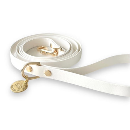 Stylish white dog leash made from high-quality vegan leather, featuring elegant gold hardware. This waterproof leash is soft to the touch, ensuring comfort for pet owners while providing durability for everyday walks. Ideal for pet owners looking for a fashionable, and long-lasting accessory for their dog