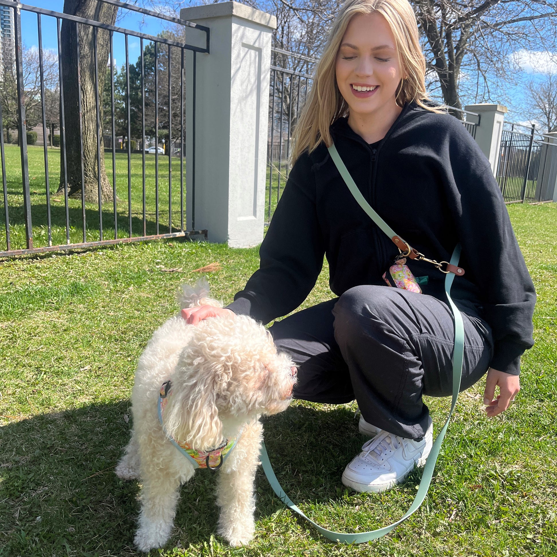  Two Tone Hands-free dog leash made from soft, waterproof vegan leather, featuring durable shiny gold hardware. Versatile design allows for crossbody or around the waist wear, perfect for training or carrying essentials. Our gold charm adds a stylish touch for modern pet owners