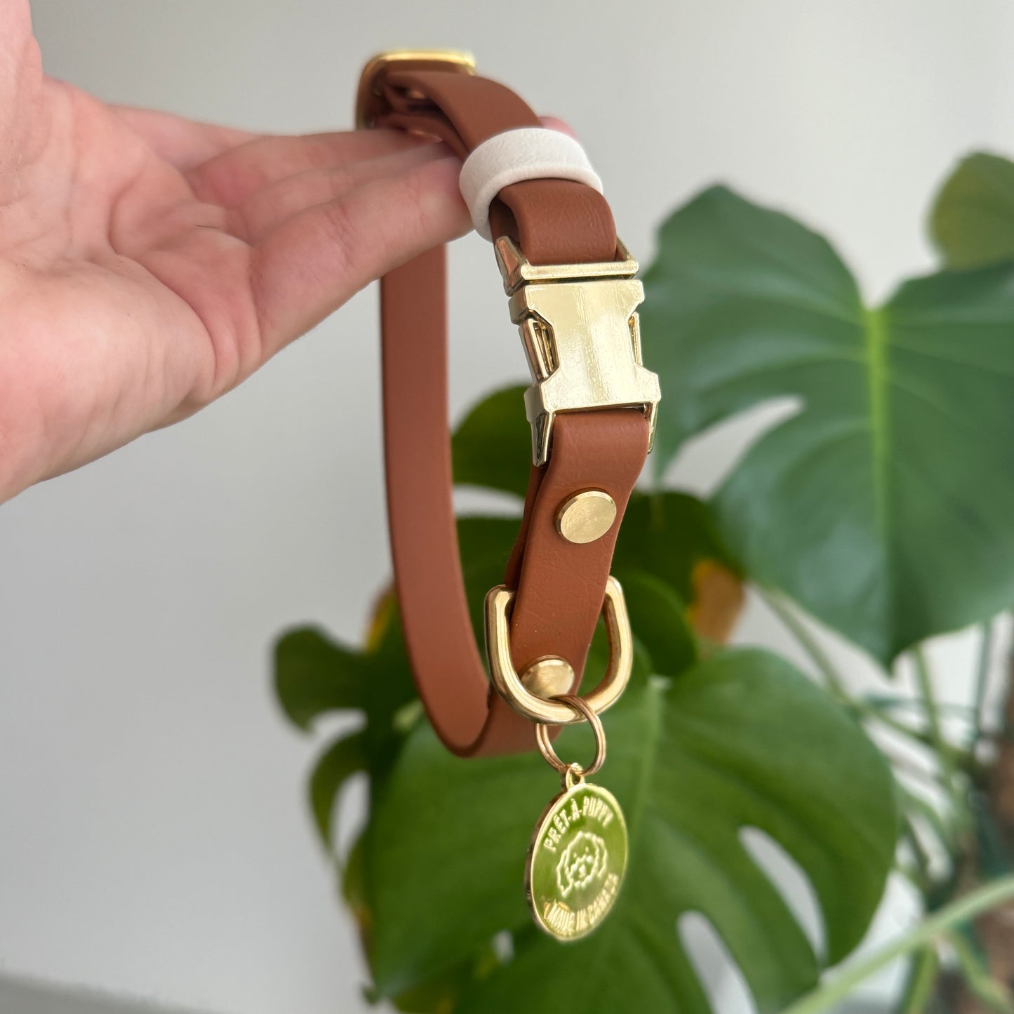 Stylish light brown waterproof vegan leather dog collar with gold hardware, durable and fashionable for everyday use in all weather conditions